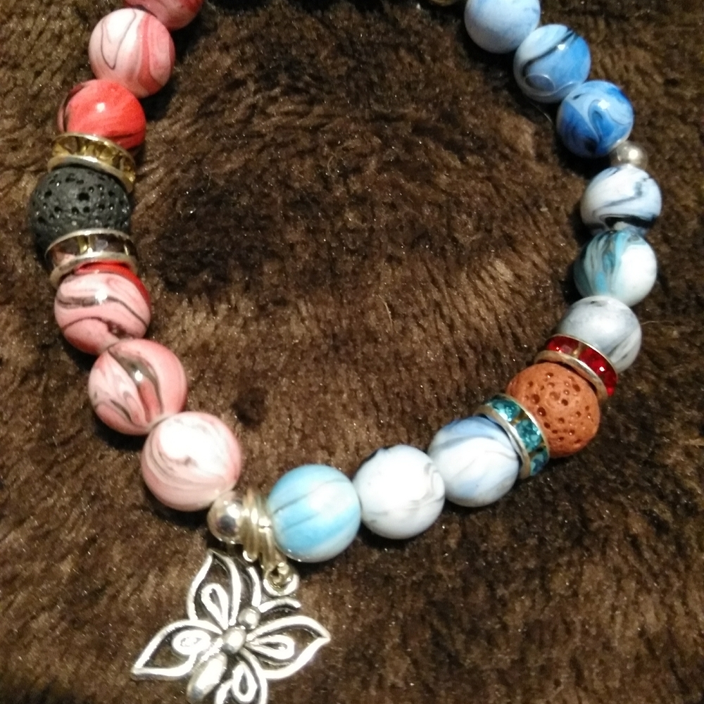 Butterfly beaded stretchy bracelet. Two toned with silver charm. New original